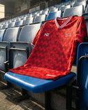 Native Nature Red sports jersey with a pattern on a blue stadium seat